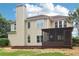 Back exterior featuring a chimney, screened porch, and well-maintained yard at 9744 Spyglass Dr, Villa Rica, GA 30180