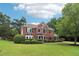 Attractive two-story house with mature trees and manicured landscaping, enhancing the curb appeal of the property at 9744 Spyglass Dr, Villa Rica, GA 30180