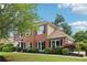 Attractive two-story home featuring a lush green lawn, mature tree, and well-manicured landscaping at 9744 Spyglass Dr, Villa Rica, GA 30180
