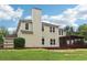Home's back exterior view showcasing a screened-in porch, chimney, and backyard at 9744 Spyglass Dr, Villa Rica, GA 30180