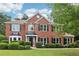Charming two-story brick home with manicured lawn, black shutters, and mature landscaping at 9744 Spyglass Dr, Villa Rica, GA 30180