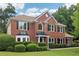 Classic two-story brick house with manicured bushes, offering a timeless charm at 9744 Spyglass Dr, Villa Rica, GA 30180