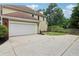 Home exterior featuring a two-car garage, driveway, and neat landscaping at 9744 Spyglass Dr, Villa Rica, GA 30180