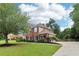 Charming two-story home with manicured lawn, complemented by mature trees and a well-maintained driveway at 9744 Spyglass Dr, Villa Rica, GA 30180