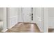 Bright foyer with beautiful columns, hardwood floors, and white wainscoting at 9744 Spyglass Dr, Villa Rica, GA 30180