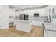 Modern kitchen features stainless appliances, white cabinetry, and granite countertops at 9744 Spyglass Dr, Villa Rica, GA 30180