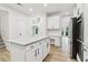 Open kitchen with granite island, stainless steel appliances, and white cabinetry at 9744 Spyglass Dr, Villa Rica, GA 30180