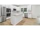 Kitchen boasts stainless steel appliances, granite countertops, and center island at 9744 Spyglass Dr, Villa Rica, GA 30180