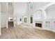 Open-concept living room with hardwood floors, fireplace, and staircase at 9744 Spyglass Dr, Villa Rica, GA 30180