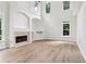 Bright living room featuring vaulted ceilings, large windows, and a fireplace at 9744 Spyglass Dr, Villa Rica, GA 30180
