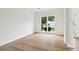 Bright, open living area with large window, and light wood flooring at 9744 Spyglass Dr, Villa Rica, GA 30180