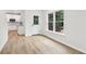 Bright living space with light wood flooring, and access to a screened-in porch at 9744 Spyglass Dr, Villa Rica, GA 30180