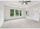Bright main bedroom with a ceiling fan and windows overlooking the lush yard at 9744 Spyglass Dr, Villa Rica, GA 30180