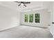 Inviting carpeted main bedroom featuring bright natural light from large windows at 9744 Spyglass Dr, Villa Rica, GA 30180