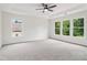 Spacious main bedroom with tray ceiling and large windows overlooking the surrounding greenery at 9744 Spyglass Dr, Villa Rica, GA 30180