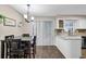 Dining area blending into the kitchen features a modern dining table, chandelier, and slider doors at 1066 Wedgewood Ln, Tucker, GA 30084