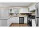 Bright kitchen featuring stainless appliances, wooden floor and white cabinets at 1066 Wedgewood Ln, Tucker, GA 30084