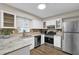 Bright kitchen with stainless steel appliances and white cabinets at 1066 Wedgewood Ln, Tucker, GA 30084