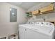 Convenient laundry area with washer, dryer, and wire shelving at 1066 Wedgewood Ln, Tucker, GA 30084