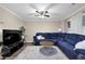 Cozy living room features a large blue sectional sofa, ceiling fan, and neutral walls for relaxation at 1066 Wedgewood Ln, Tucker, GA 30084