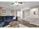Inviting living room featuring a comfortable blue sofa and stairs to the upper level at 1066 Wedgewood Ln, Tucker, GA 30084