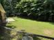 Large, grassy backyard with mature trees and a chain link fence at 2990 Piedmont Dr, Marietta, GA 30066