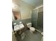 A bathroom with blue tile, a walk-in shower, and standard fixtures at 2990 Piedmont Dr, Marietta, GA 30066