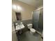 Bathroom featuring a tiled wall sink, toilet, and walk-in shower at 2990 Piedmont Dr, Marietta, GA 30066