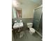 A bathroom with blue tile, a walk-in shower, and standard fixtures at 2990 Piedmont Dr, Marietta, GA 30066