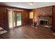 Inviting living room featuring a brick fireplace, wood paneling, and natural light at 2990 Piedmont Dr, Marietta, GA 30066