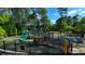 A playground with slides and climbing structures surrounded by greenery at 2990 Piedmont Dr, Marietta, GA 30066