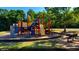 A playground with colorful climbing structures and slides in a park setting at 2990 Piedmont Dr, Marietta, GA 30066