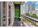 Condo balcony featuring an outdoor bar area with city view, and views through the sliding doors to the unit at 390 17Th Nw St # 6055, Atlanta, GA 30363
