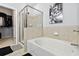Clean bathroom featuring a shower with glass enclosure, soaking tub and a view into the walk-in closet at 390 17Th Nw St # 6055, Atlanta, GA 30363