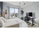 Well-lit bedroom with a large window providing natural light, a dedicated workstation, and a stylish interior at 390 17Th Nw St # 6055, Atlanta, GA 30363