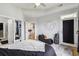 A bright bedroom featuring hardwood floors, a ceiling fan, and views of the en-suite bathroom at 390 17Th Nw St # 6055, Atlanta, GA 30363