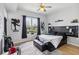 Bright bedroom featuring hardwood floors, large window with city views, a ceiling fan, and modern decor at 390 17Th Nw St # 6055, Atlanta, GA 30363
