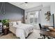 Chic bedroom featuring city views, modern decor, with light color walls and an adjacent workspace at 390 17Th Nw St # 6055, Atlanta, GA 30363