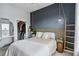 A cozy bedroom with designer elements, a dark accent wall, a bedside table, and a walk-in closet at 390 17Th Nw St # 6055, Atlanta, GA 30363