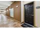 Hallway shot showing the unit's front door, hallway decor, and unit number with the welcome mat at 390 17Th Nw St # 6055, Atlanta, GA 30363