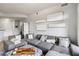 Living room with a large gray sectional couch, and decorations hanging on the wall at 390 17Th Nw St # 6055, Atlanta, GA 30363