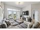 Bright living room features a large sectional, modern lighting, and balcony access at 390 17Th Nw St # 6055, Atlanta, GA 30363