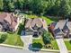 Aerial view of a home featuring a well-maintained yard, mature trees, and a private backyard at 4050 Bonnett Creek Ln, Hoschton, GA 30548