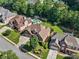 Aerial shot of a beautiful home showcasing lush greenery, mature trees, and a well-manicured lawn at 4050 Bonnett Creek Ln, Hoschton, GA 30548