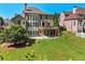 Expansive backyard with lush greenery, a stone patio, and a deck; ideal for relaxation at 4050 Bonnett Creek Ln, Hoschton, GA 30548