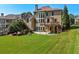 Large backyard features a stone patio, deck, and lush lawn, perfect for outdoor gatherings at 4050 Bonnett Creek Ln, Hoschton, GA 30548