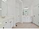 Clean bathroom showcases double doors, vanity, and tiled floors at 4050 Bonnett Creek Ln, Hoschton, GA 30548