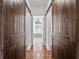 Hallway view to bathroom with sliding doors and decorative lighting at 4050 Bonnett Creek Ln, Hoschton, GA 30548