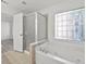 Bright bathroom with a soaking tub and a glass-enclosed shower at 4050 Bonnett Creek Ln, Hoschton, GA 30548