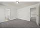Cozy bedroom with neutral walls, carpet, and access to the ensuite bathroom and upper level at 4050 Bonnett Creek Ln, Hoschton, GA 30548